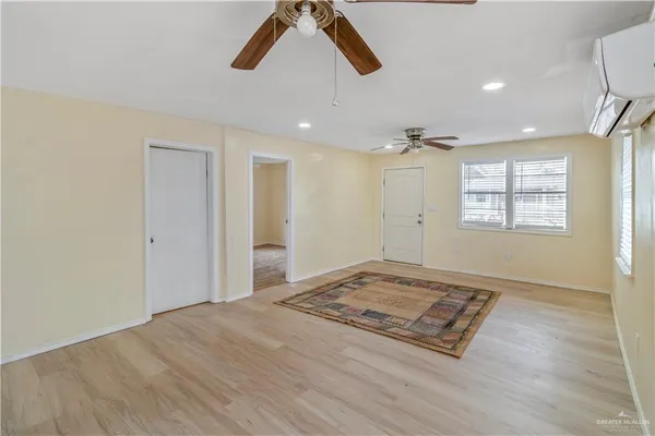 a view of an empty room and a window