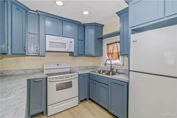 a kitchen with a sink stove and cabinets