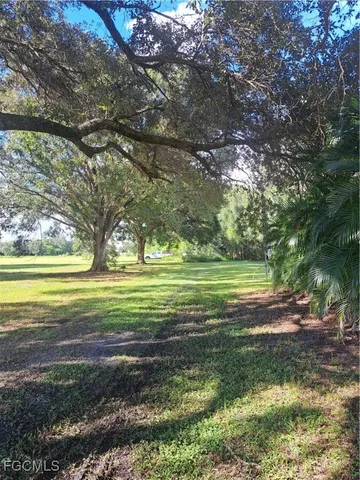 a view of a house with a yard and sitting area