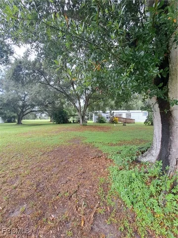 a kitchen with stainless steel appliances a sink a stove a refrigerator cabinets and a table