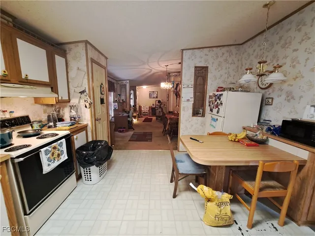 a living room with furniture and a lamp