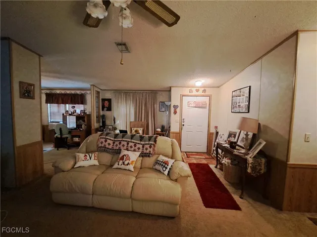 a living room with furniture a rug and a window