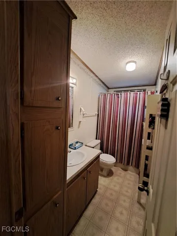 a large kitchen with a table chairs wooden floor and a window