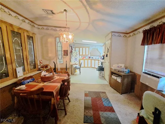 a large kitchen with a table chairs wooden floor and a window
