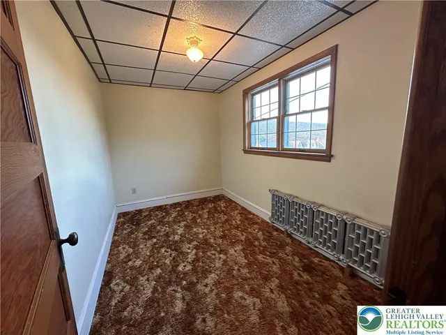 a view of a room with window and wooden floor