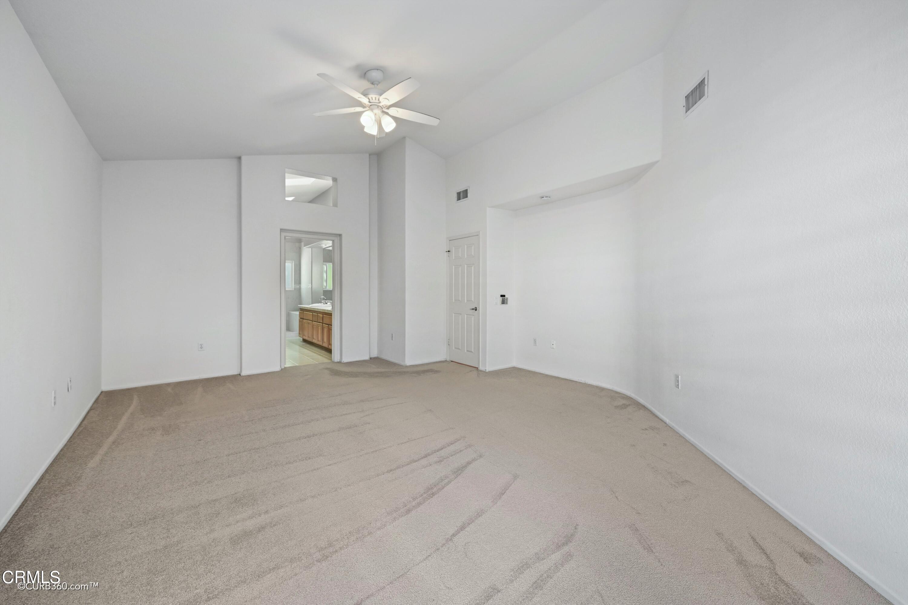 4947 Tilos Way Oceanside, CA 92056 - Photo 14 of 37 a view of an empty room with a fan