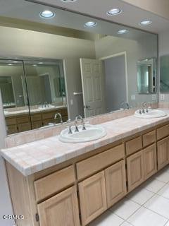4947 Tilos Way Oceanside, CA 92056 - Photo 18 of 37 a bathroom with a sink and a mirror