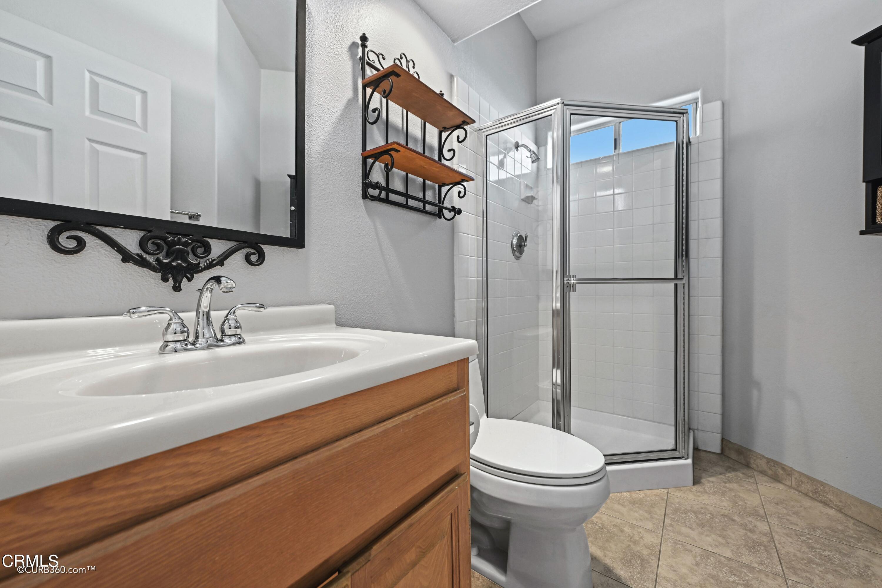 4947 Tilos Way Oceanside, CA 92056 - Photo 21 of 37 a bathroom with a sink a toilet and shower