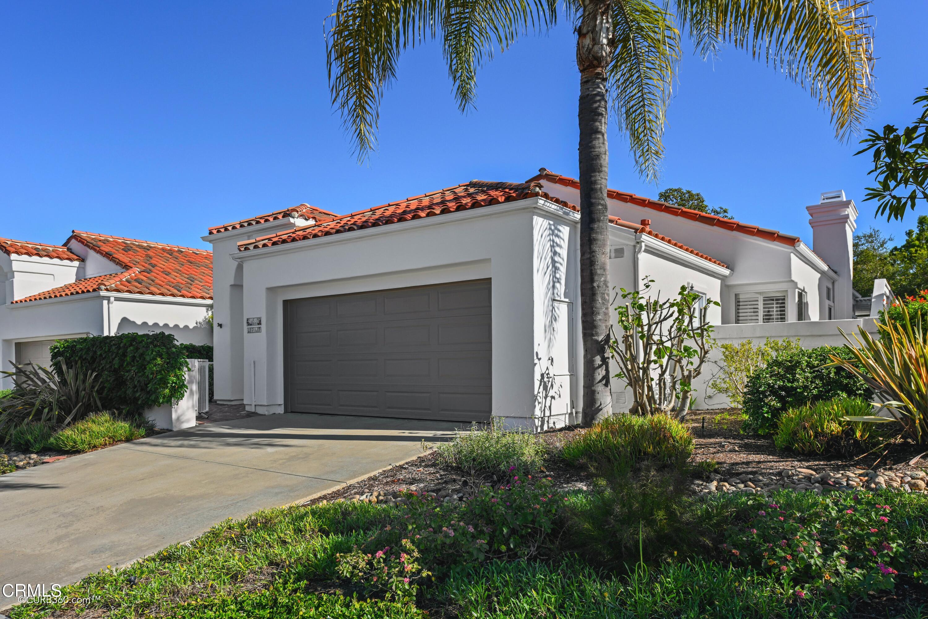 4947 Tilos Way Oceanside, CA 92056 - Photo 3 of 37 a front view of a house with a garden
