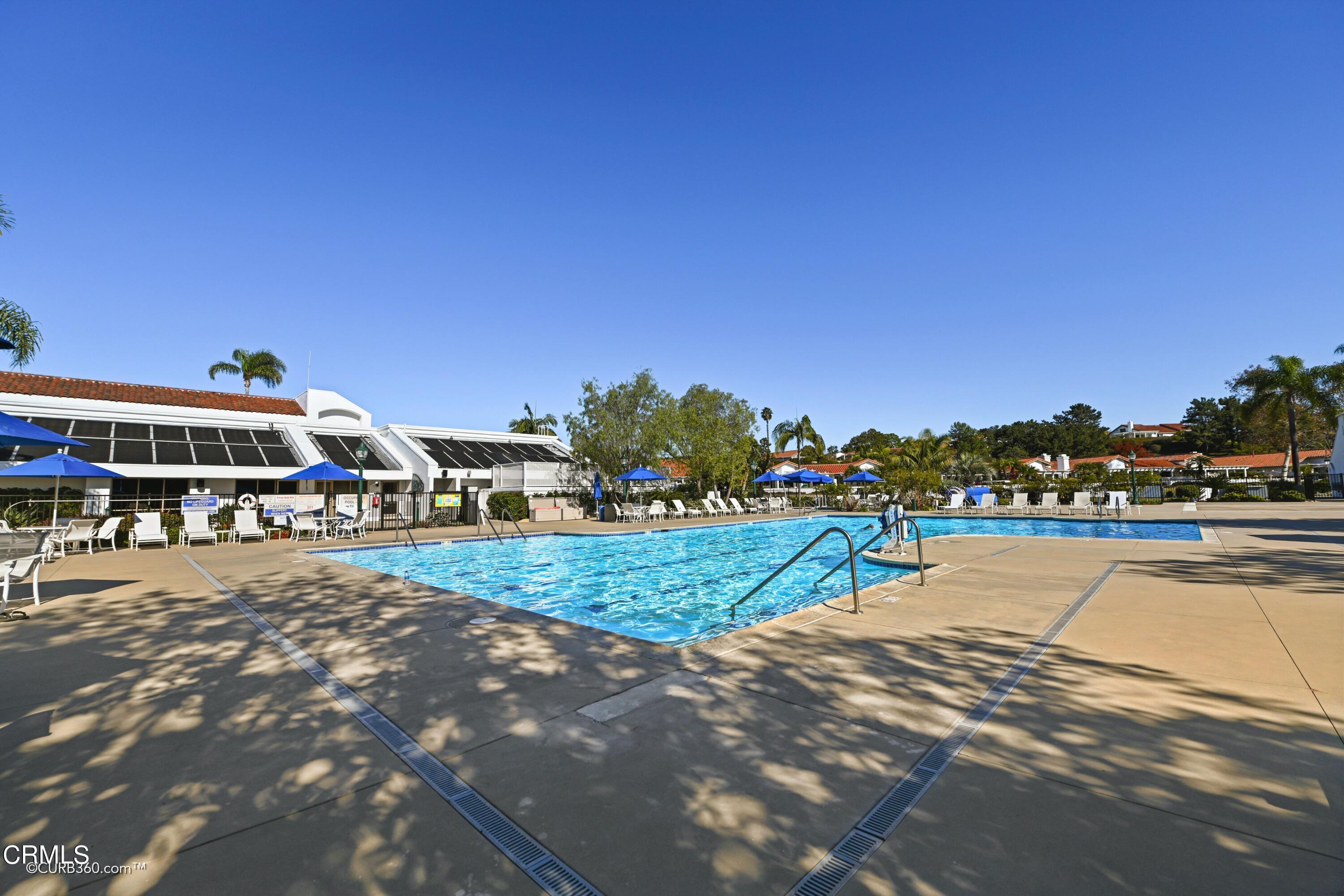4947 Tilos Way Oceanside, CA 92056 - Photo 32 of 37 a view of a house with outdoor space and trees in the background