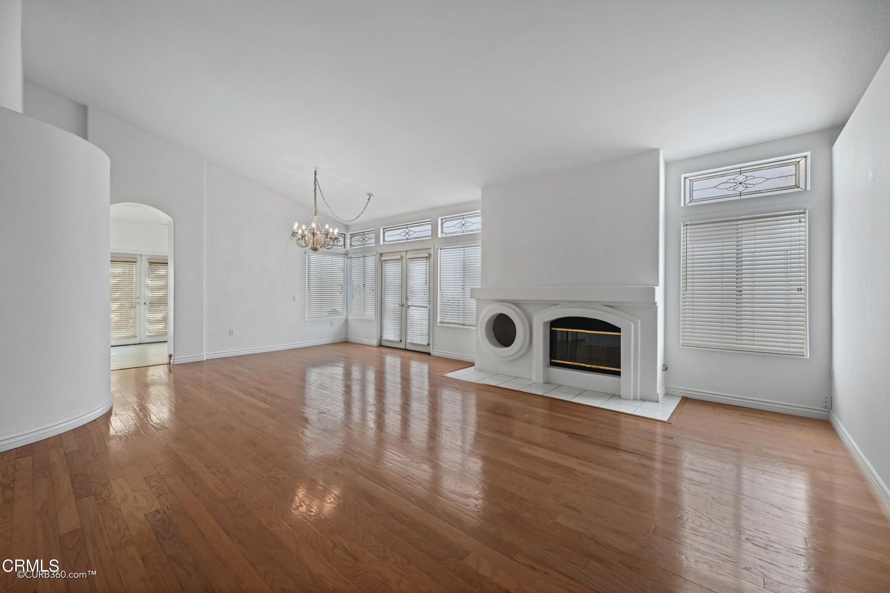 4947 Tilos Way Oceanside, CA 92056 - Photo 4 of 37 a view of empty room with wooden floor and fireplace
