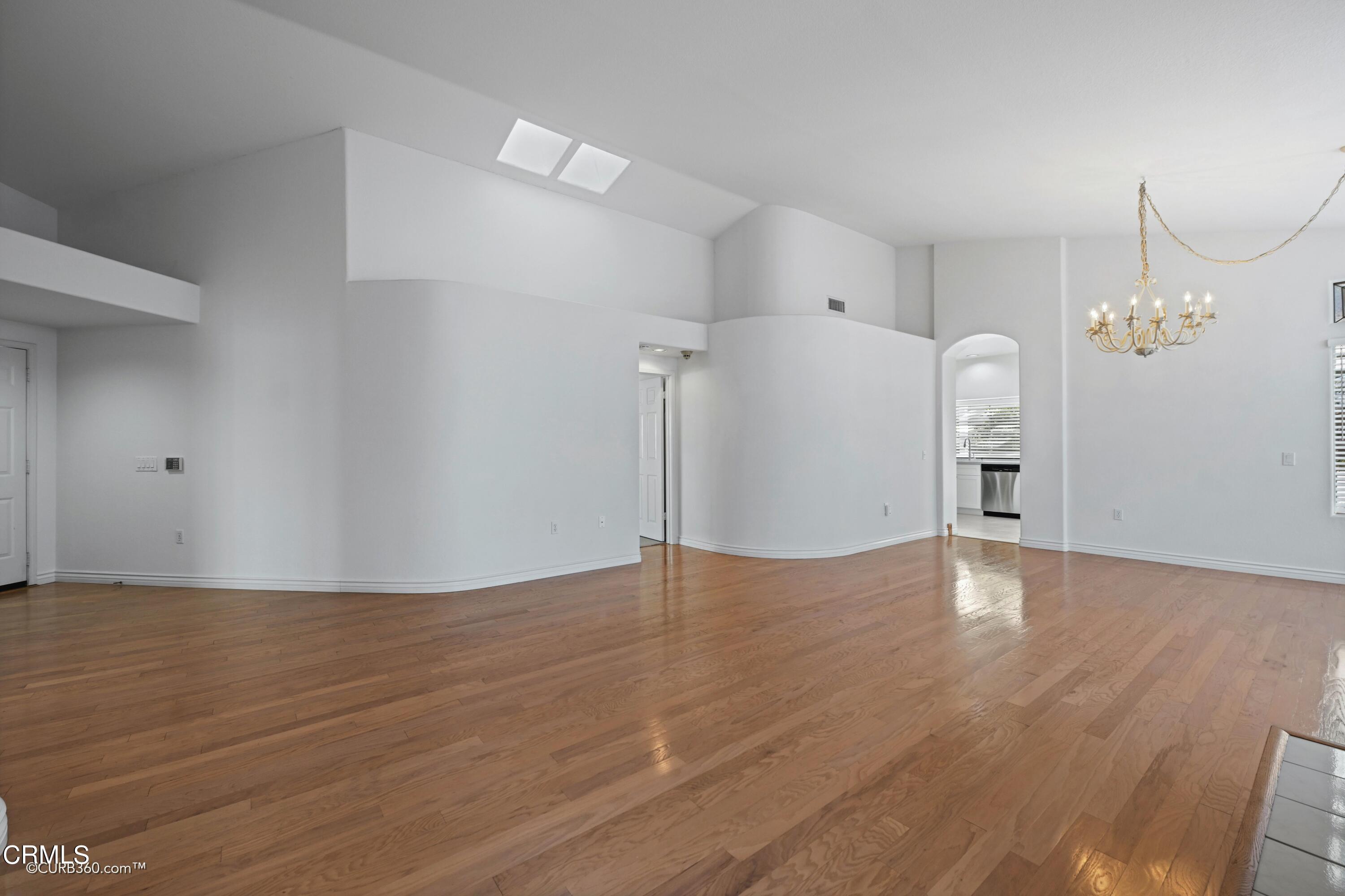 4947 Tilos Way Oceanside, CA 92056 - Photo 6 of 37 a view of empty room with wooden floor