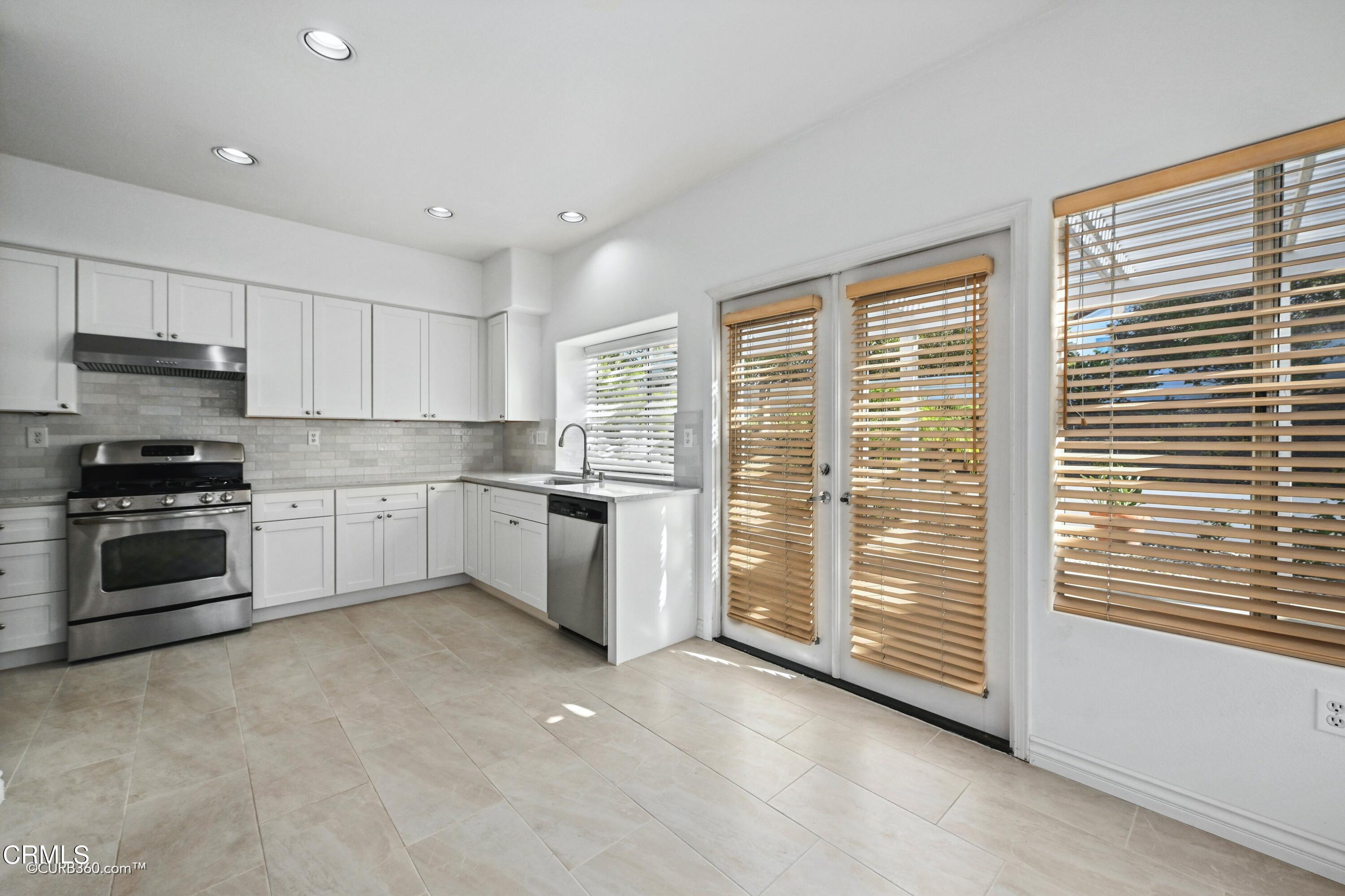 4947 Tilos Way Oceanside, CA 92056 - Photo 9 of 37 a kitchen with a stove a sink and a refrigerator