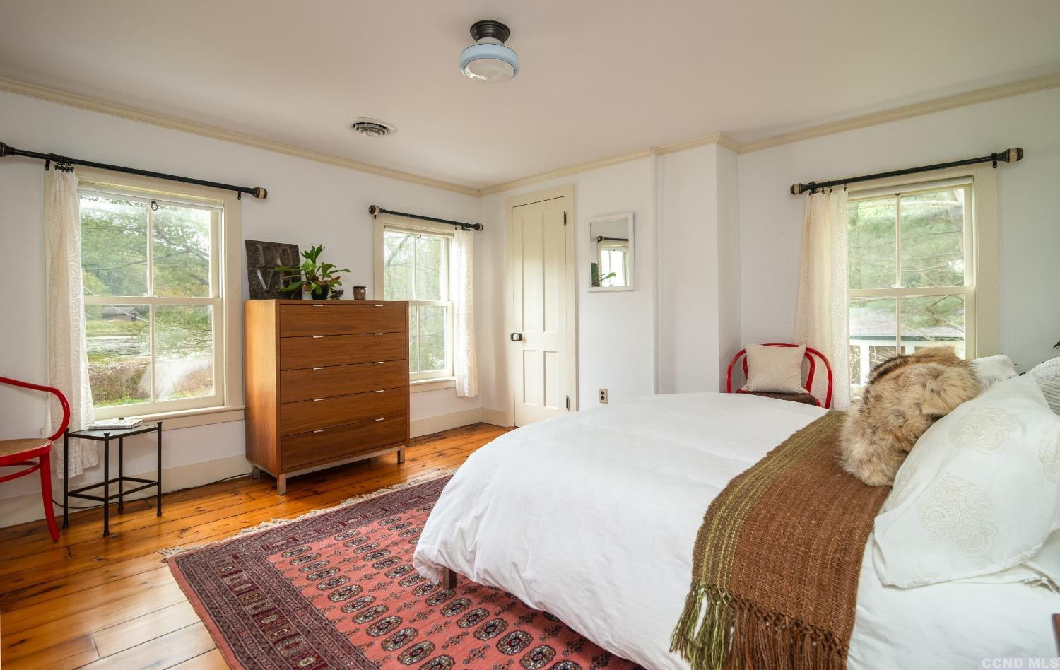 56 Beebe Pond Road Canaan, NY 12029 - Photo 21 of 50 a spacious bedroom with a bed and wooden floor