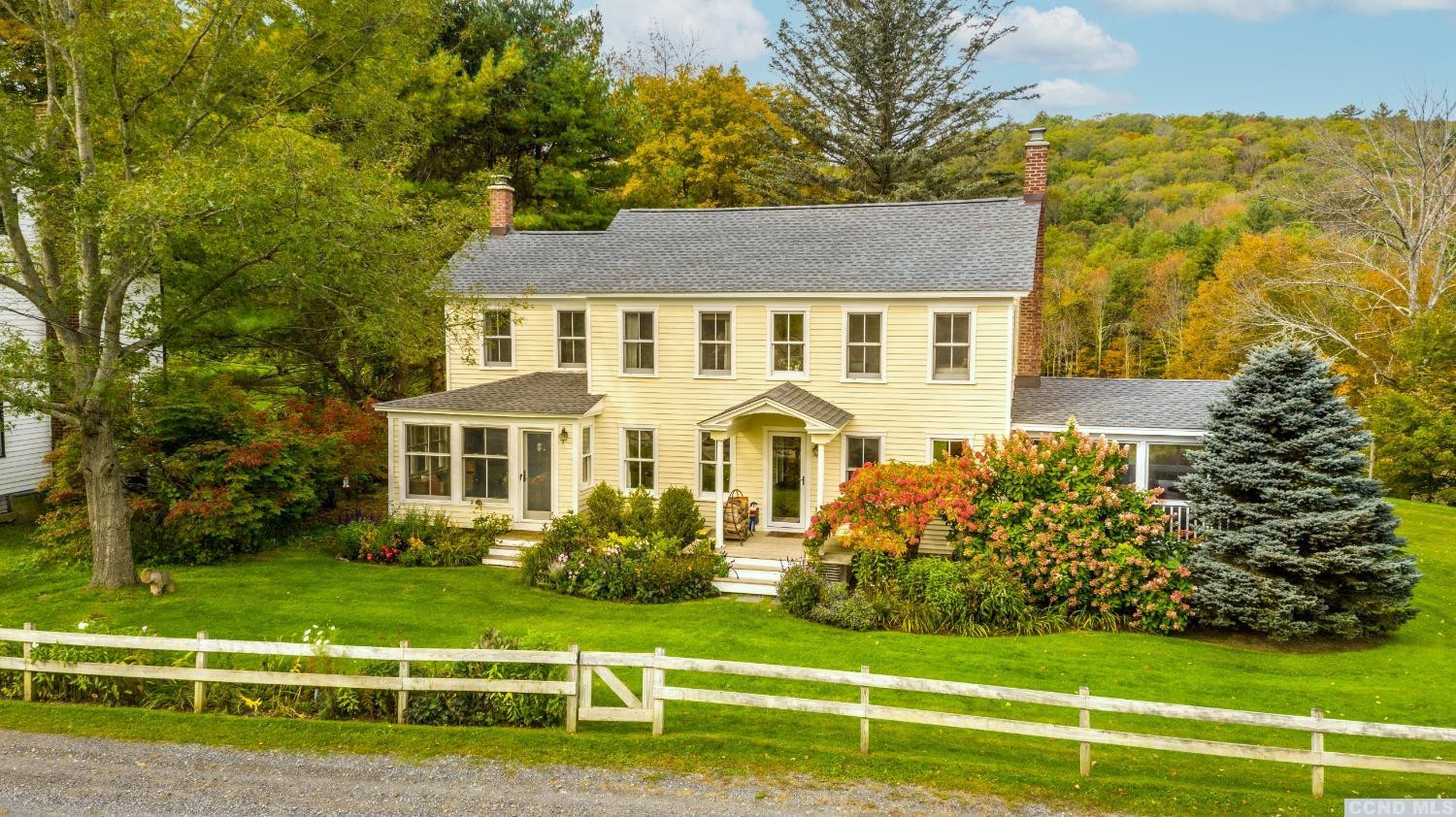 56 Beebe Pond Road Canaan, NY 12029 - Photo 30 of 50 a front view of a house with a yard table and chairs