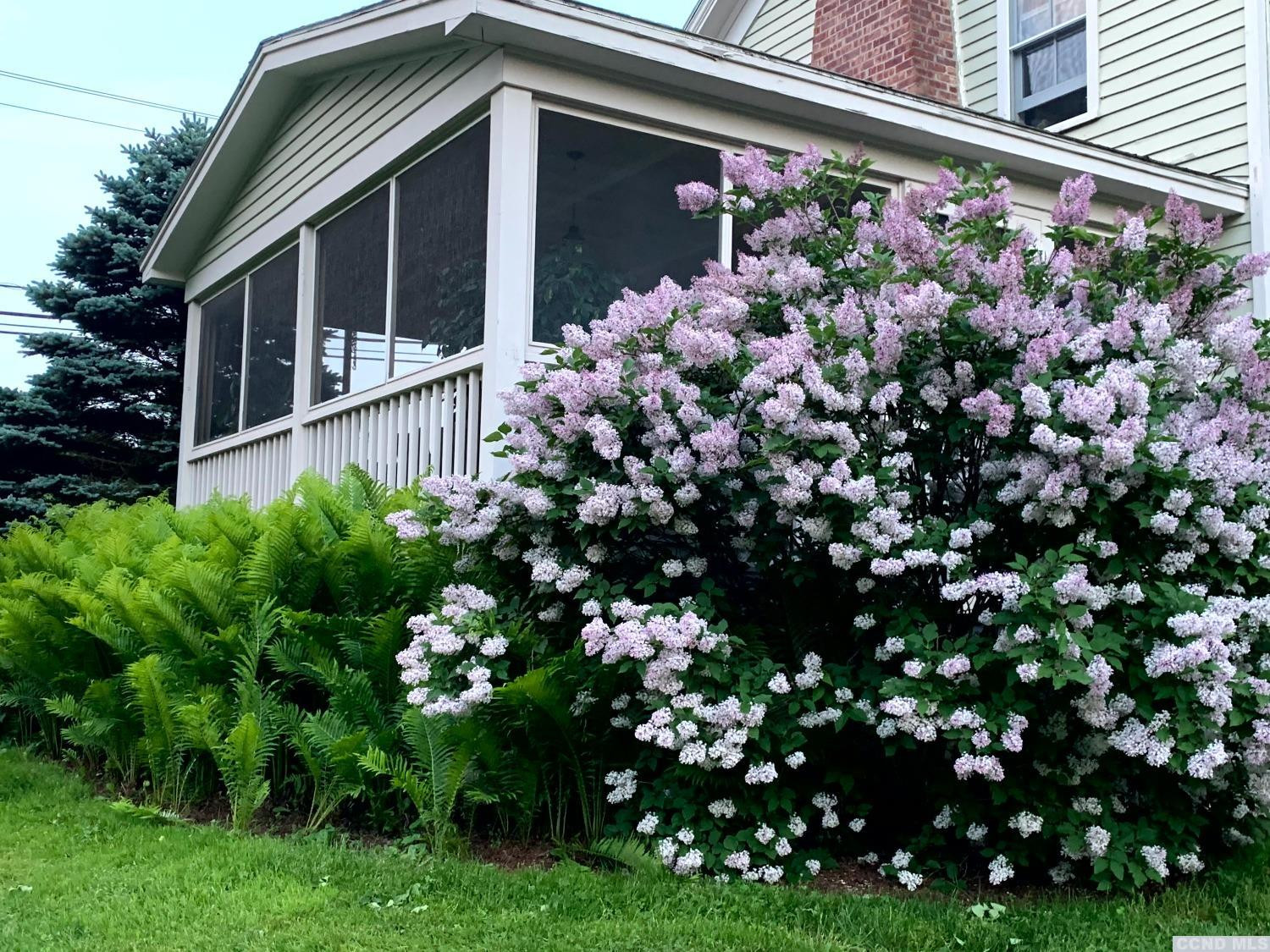 56 Beebe Pond Road Canaan, NY 12029 - Photo 43 of 50 a front view of a house with a flower garden