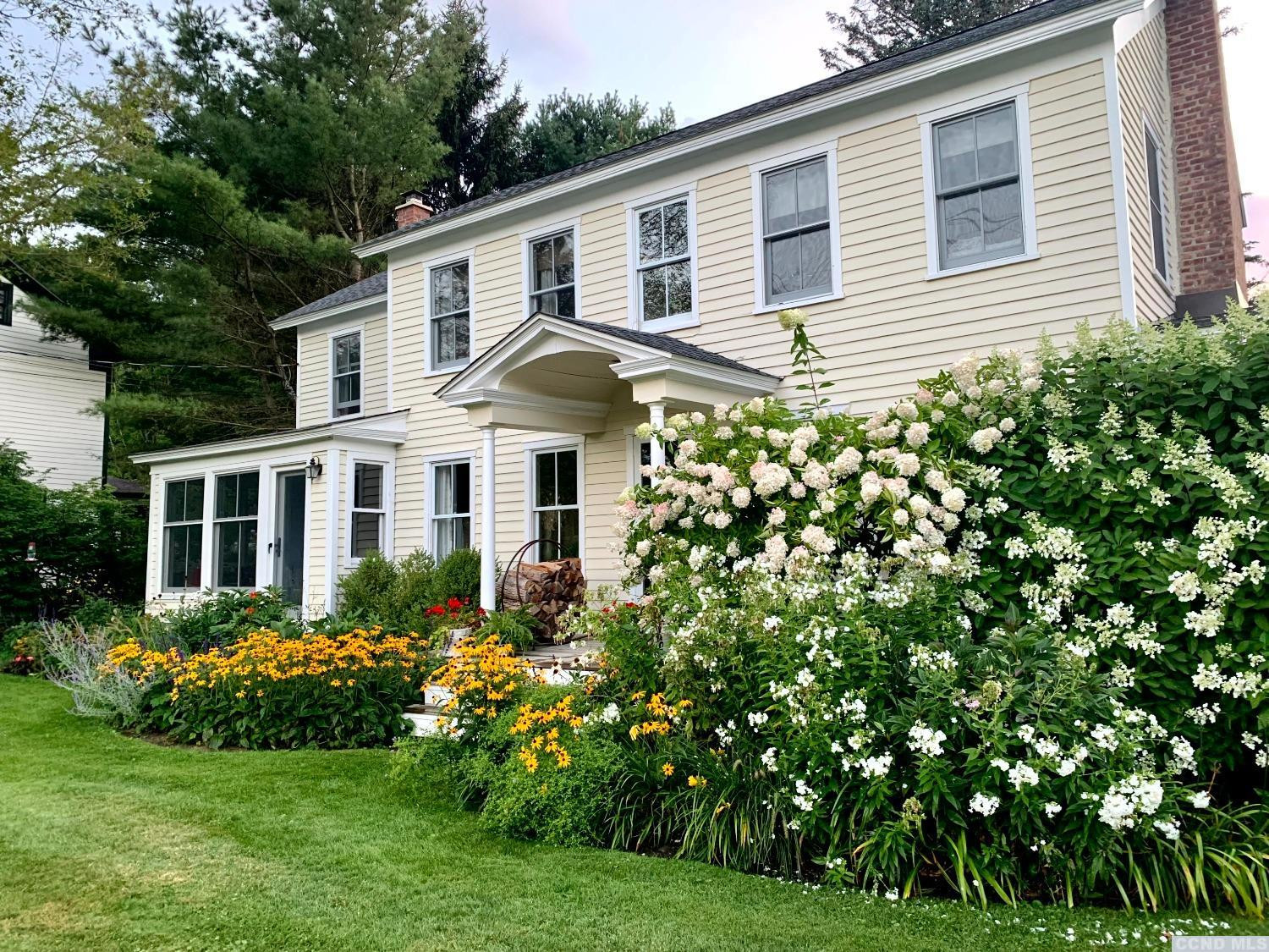 56 Beebe Pond Road Canaan, NY 12029 - Photo 45 of 50 a front view of a house with a garden