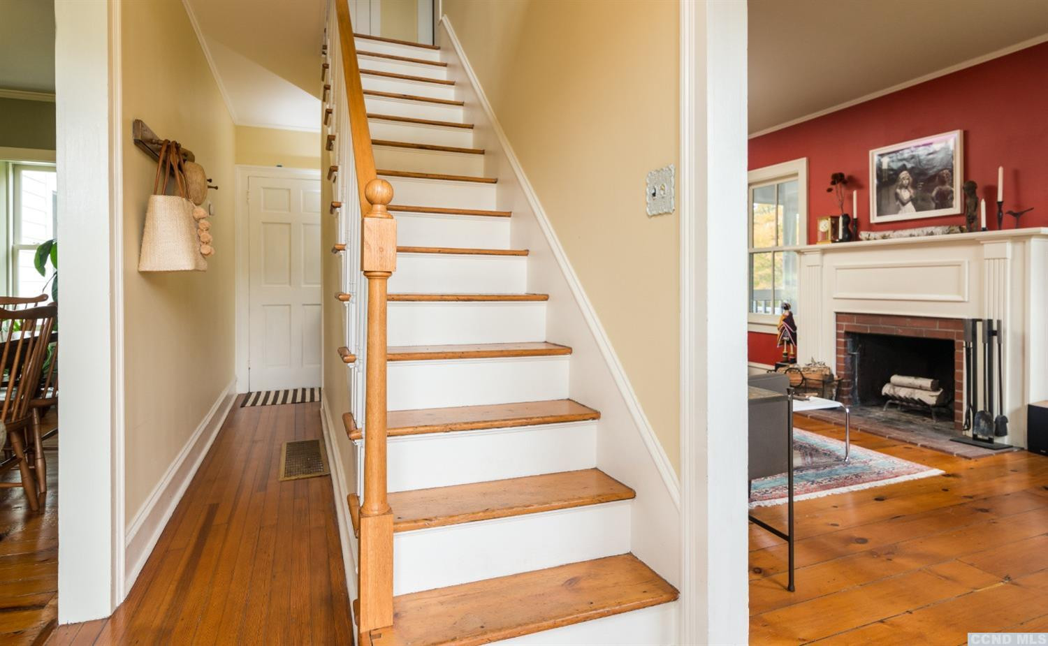 56 Beebe Pond Road Canaan, NY 12029 - Photo 8 of 50 a view of a hallway with wooden floor and a fireplace