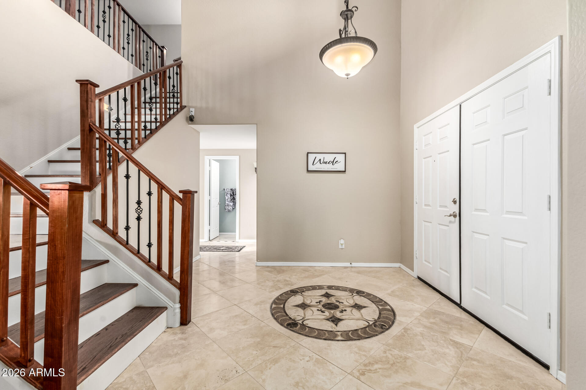 24541 Plum Road Florence, AZ 85132 - Photo 9 of 47 a view of a hallway with wooden floor and stairs