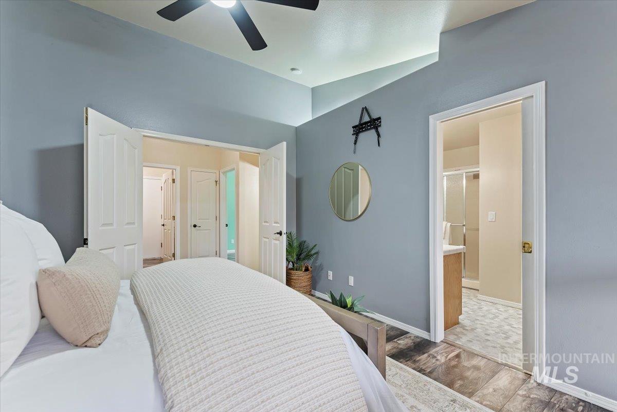 1528 East Peridot Street Meridian, ID 83646 - Photo 18 of 28 Bedroom with wood finished floors, a ceiling fan, and connected bathroom