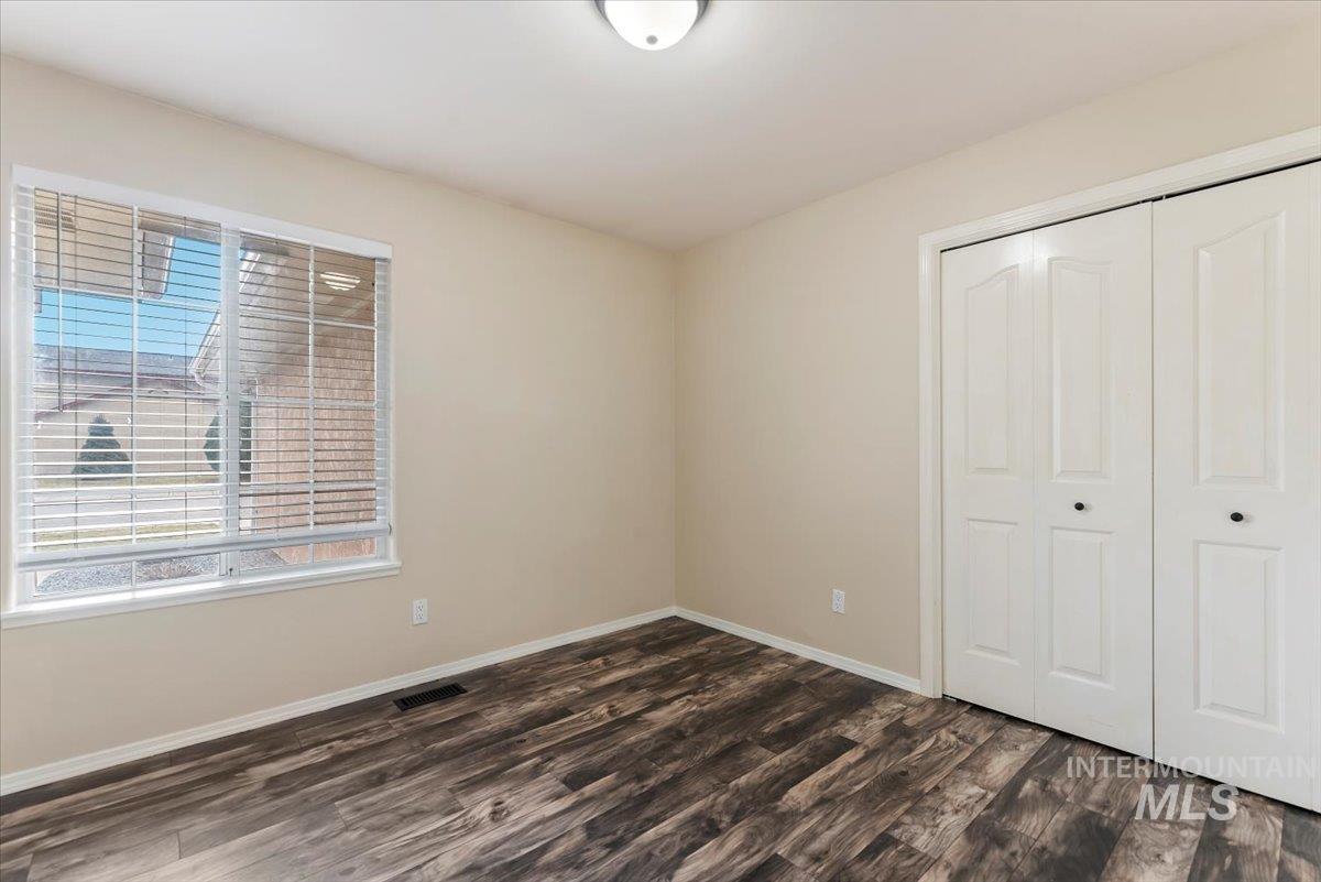 1528 East Peridot Street Meridian, ID 83646 - Photo 19 of 28 Unfurnished bedroom with a closet and dark wood-style floors