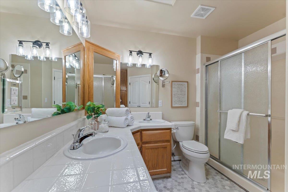 1528 East Peridot Street Meridian, ID 83646 - Photo 21 of 28 Bathroom with double vanity and a stall shower