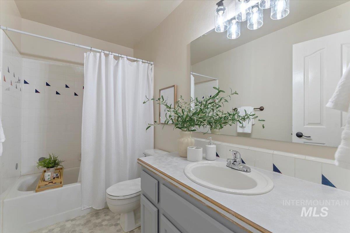 1528 East Peridot Street Meridian, ID 83646 - Photo 22 of 28 Full bathroom featuring shower / tub combo with curtain and vanity