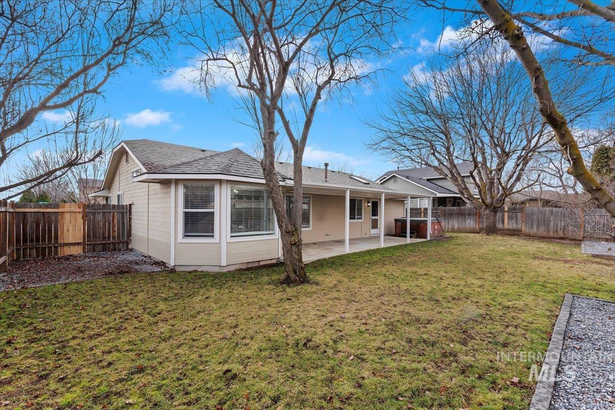 1528 East Peridot Street Meridian, ID 83646 - Photo 26 of 28 Back of property with a patio, a fenced backyard, and a shingled roof