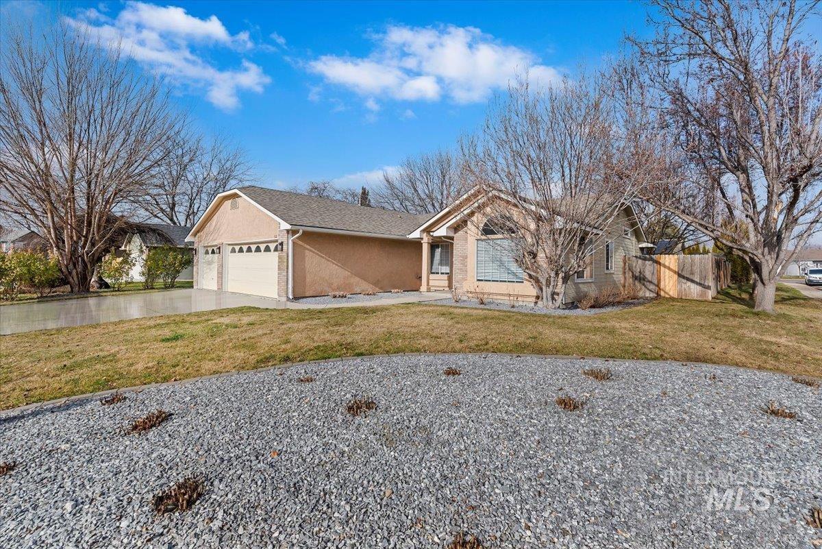 1528 East Peridot Street Meridian, ID 83646 - Photo 5 of 28 Ranch-style house with concrete driveway, stucco siding, and an attached garage