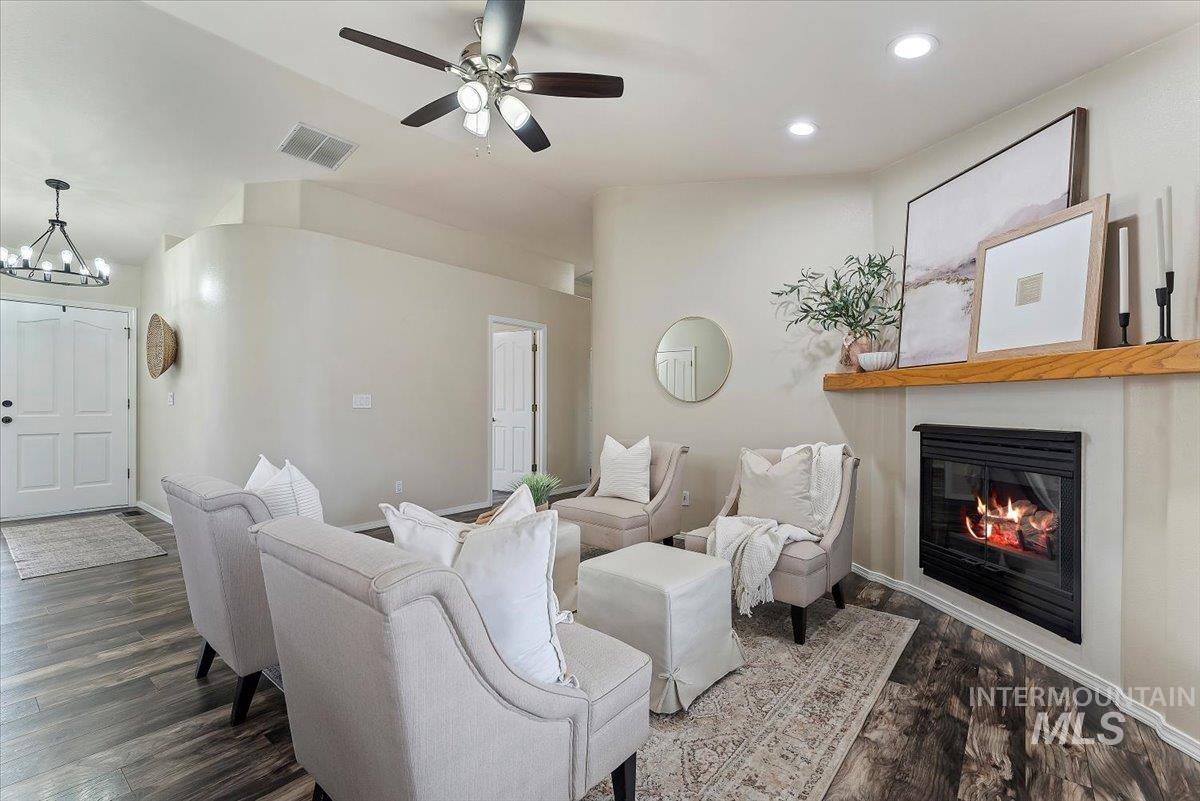 1528 East Peridot Street Meridian, ID 83646 - Photo 9 of 28 Living room featuring a glass covered fireplace, dark wood-style flooring, recessed lighting, and a ceiling fan