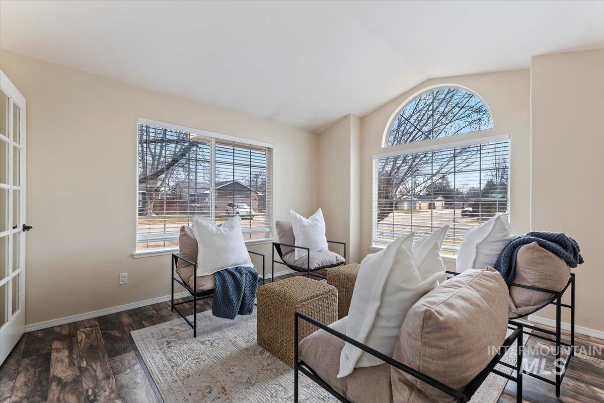 1528 East Peridot Street Meridian, ID 83646 - Photo 10 of 28 Living area featuring lofted ceiling, healthy amount of natural light, and dark wood-style floors