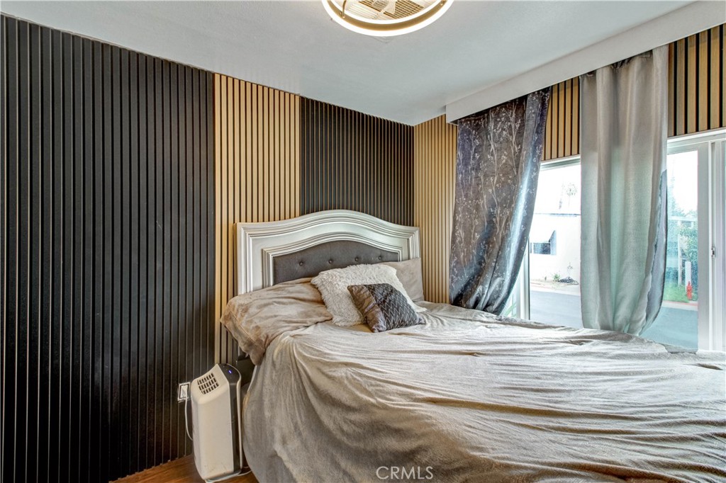 1025 South Riverside Avenue, Unit 26 Rialto, CA 92376 - Photo 23 of 27 a bedroom with a bed and a window