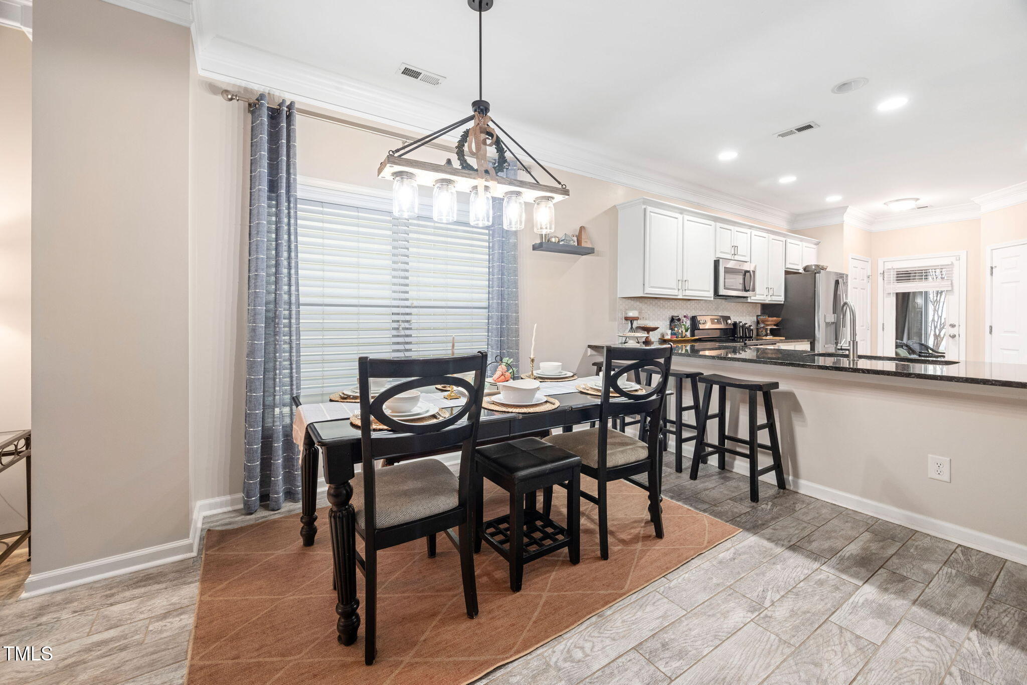 992 Ambergate Apex, NC 27502 - Photo 8 of 39 a view of a dining room with furniture and a chandelier