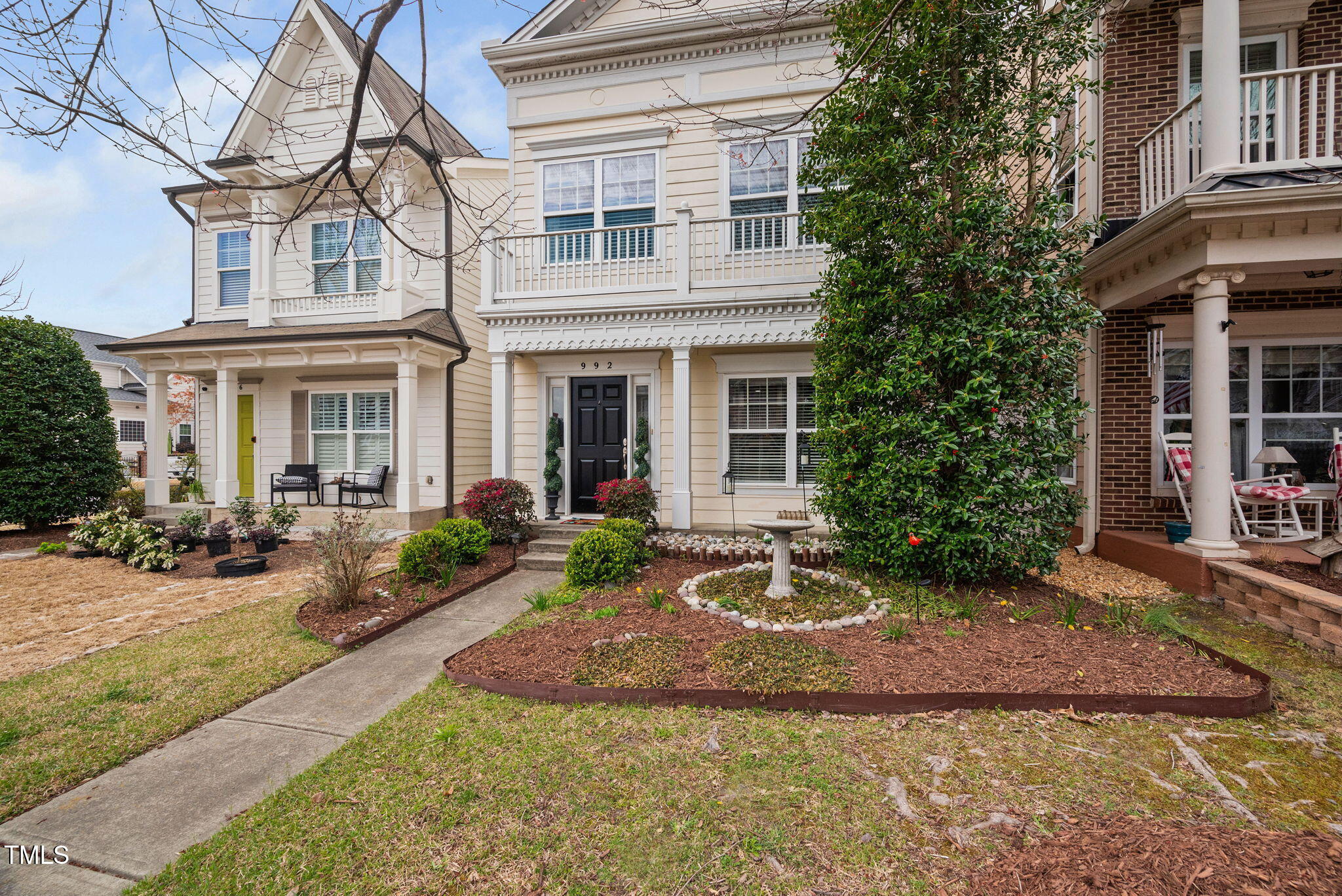 992 Ambergate Apex, NC 27502 - Photo 3 of 39 a front view of a house with garden and porch