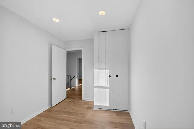 a view of hallway with wooden floor