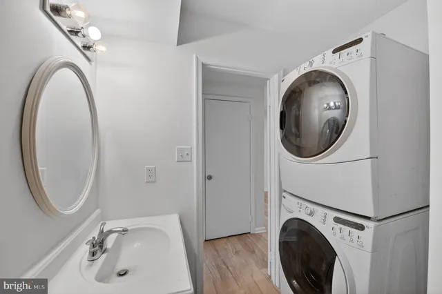 a bathroom with a sink mirror and toilet