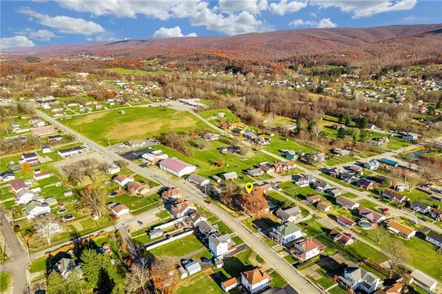 an aerial view of residential houses with outdoor space