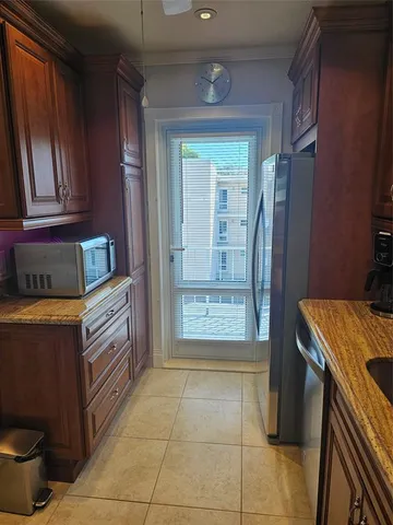 a kitchen with stainless steel appliances granite countertop a refrigerator and a stove