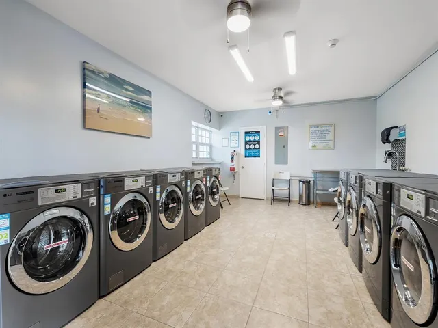 a view of a hallway with a washer and dryer