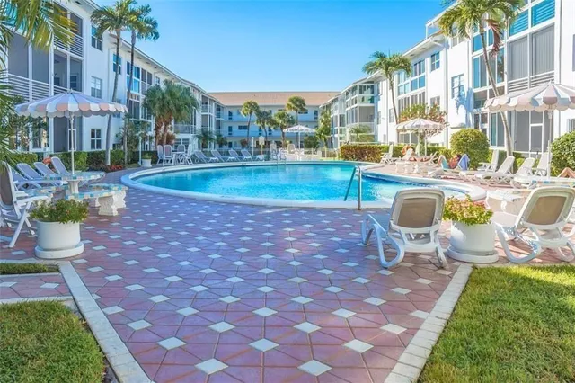 a view of a swimming pool with sitting area