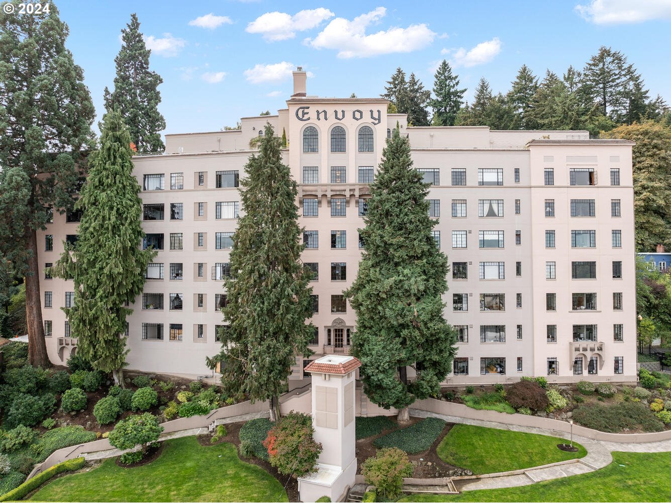 a view of a building with garden and trees