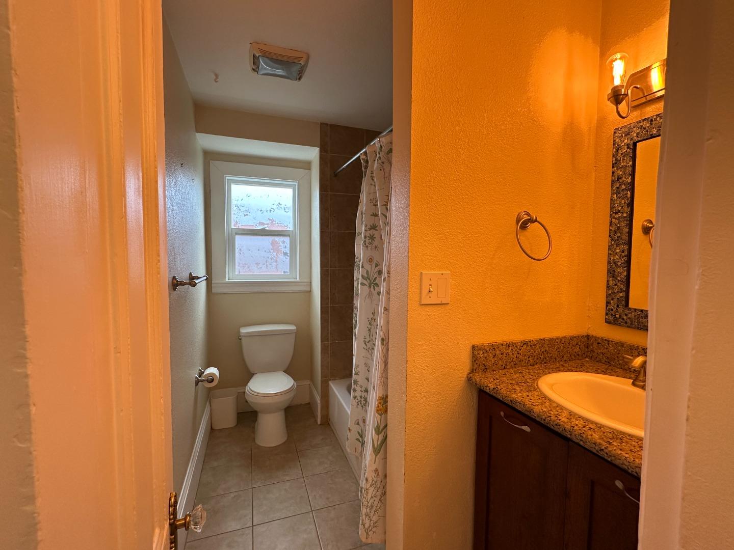 69 Geil Street Salinas, CA 93901 - Photo 18 of 34 a bathroom with a granite countertop sink toilet and shower