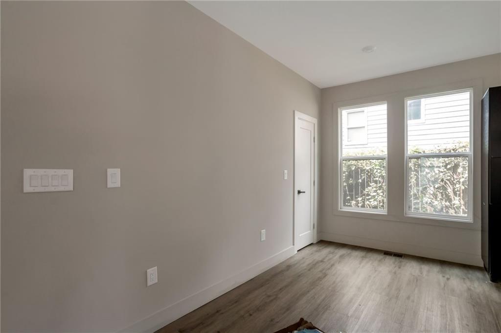 3139 Alston Drive Decatur, GA 30032 - Photo 14 of 40 a view of an empty room with a window and wooden floor