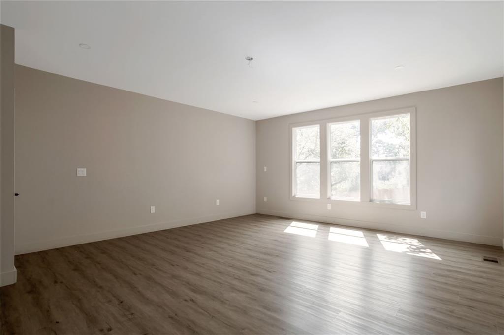 3139 Alston Drive Decatur, GA 30032 - Photo 17 of 40 an empty room with wooden floor and windows