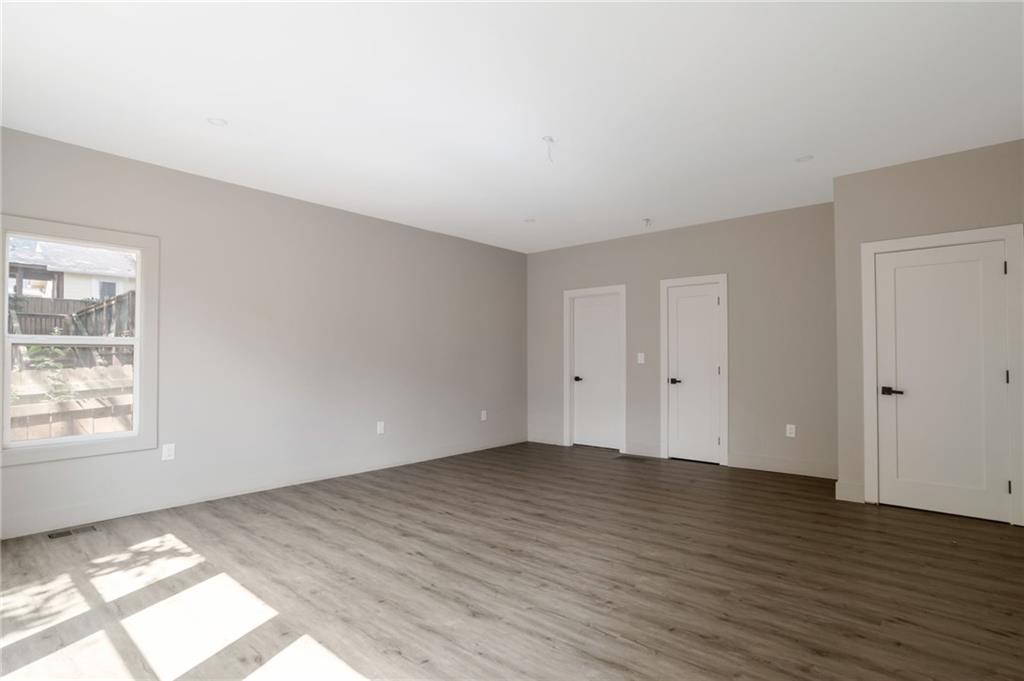 3139 Alston Drive Decatur, GA 30032 - Photo 18 of 40 an empty room with wooden floor and windows