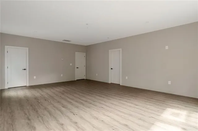 a view of an empty room and wooden floor