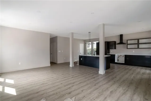 a view of a kitchen with a sink and a large window