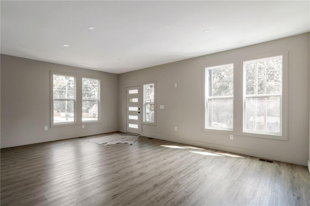 3139 Alston Drive Decatur, GA 30032 - Photo 8 of 40 a view of an empty room with wooden floor and a window
