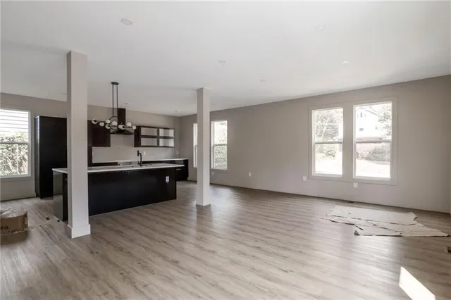 a large kitchen with a wooden floor and a large window