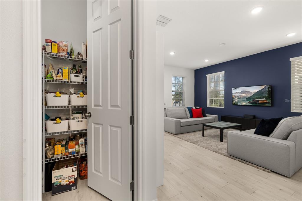 1849 Island Village Way Celebration, FL 34747 - Photo 14 of 50 a living room with furniture and a book shelf